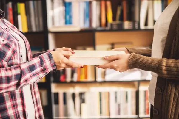 Participants in the Sinhala Dhamma Audiobook Library Book Swap Program exchanging books.
