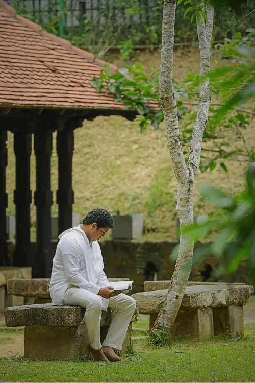 Fourth image of the Sinhala Dhamma audiobook library's volunteer-sign-up page, showing a volunteer editing an audiobook in the studio